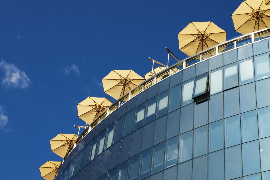 Yellow umbrellas on top of a building.