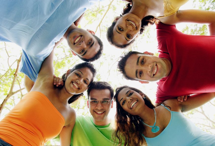 A group of people standing together in a circle.