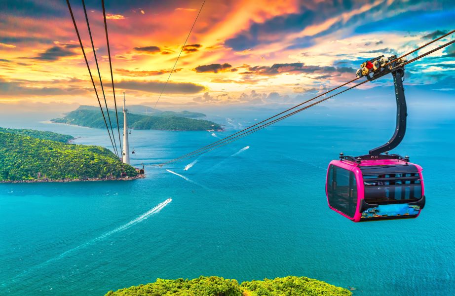 A gondola ride over the ocean at sunset.