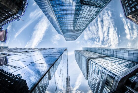 A view of looking up at skyscrapers in a city.