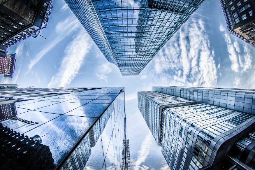 A view of looking up at skyscrapers in a city.