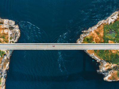 An aerial view of a bridge over a body of water.