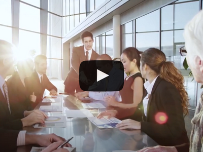 A group of business people sitting around a conference table.