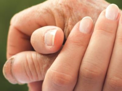 A close up photo of holding hands together.