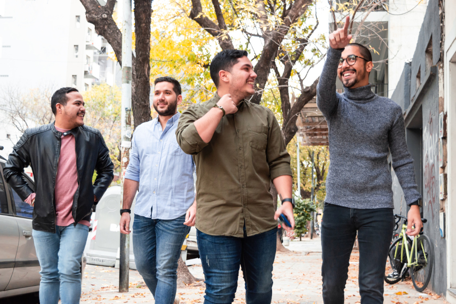 A group of men walking down a city street.