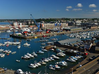 An aerial view of a harbor with boats docked in it.