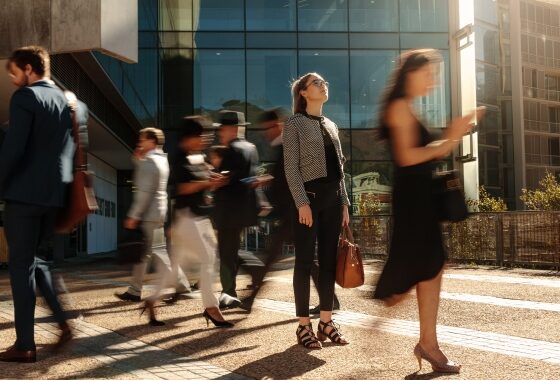 A group of business people walking down a street.