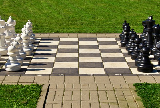 Black and white chess pieces on a chess board.