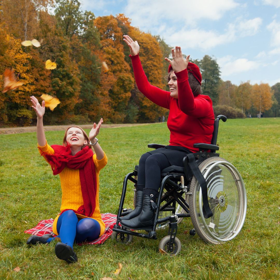 Disabled ladies celebrating finding a new Infor SunSystems partner