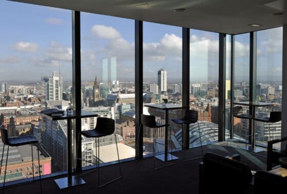 Skyline view from roof top bar with tall buildings and cloudy sky